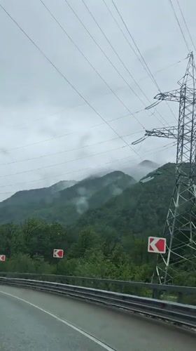 Vehicle travels two-lane road in Krasnaya Polyana, Russia