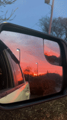 Vibrant sunset captured in car mirrors in Newburgh