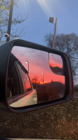 Vibrant sunset captured in car mirrors in Newburgh
