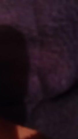 This is a close-up, low-light video of a dark, textured surface, possibly fabric. The image is out of focus and predominantly dark, with some lighter areas that may indicate variations in texture or light reflection. The overall impression is of a dimly lit, underexposed scene.