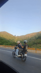 Black pickup truck filmed on Venezuelan roadway near hills
