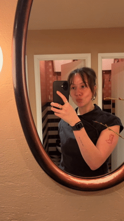 Woman takes bathroom mirror selfie in London