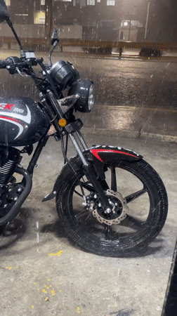 Motorcycle parked in heavy rain, Turmero, Venezuela