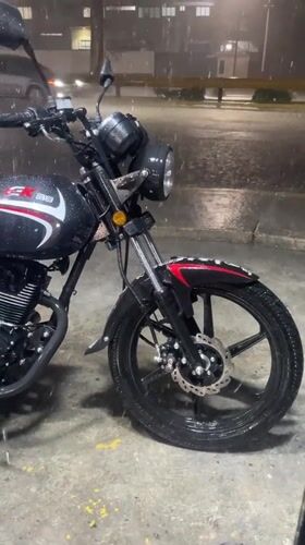 Motorcycle parked in heavy rain, Turmero, Venezuela
