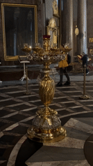 Ornate church interior with golden candelabra filmed in Saint Petersburg