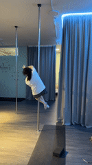 Pole fitness practice session captured at dance studio