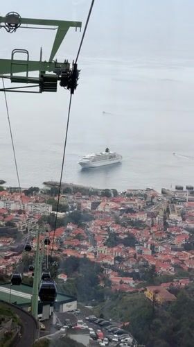Tourists ride Funchal cable cars, view city and harbor