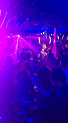 Nightclub Scene Captured with Dancing Patrons Under Colorful Lights