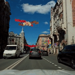 Red flags decorate sunny Saint Petersburg street scene