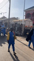 Children walk to school on Jos street Sunday morning