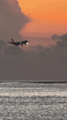 Kuta Beach sunset draws beachgoers, aircraft, ceremonial gathering