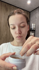 Woman performs morning skincare routine in Reshetnikovo, Russia