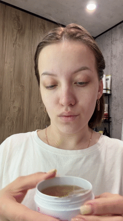 Woman performs morning skincare routine in Reshetnikovo, Russia