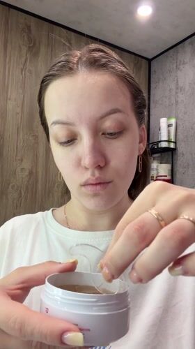 Woman performs morning skincare routine in Reshetnikovo, Russia
