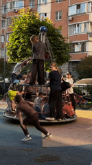 Children play on rope climbing structure at Khimki playground