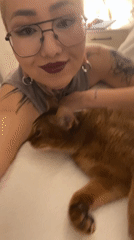 Chilling with a brown cat, tattoos on display