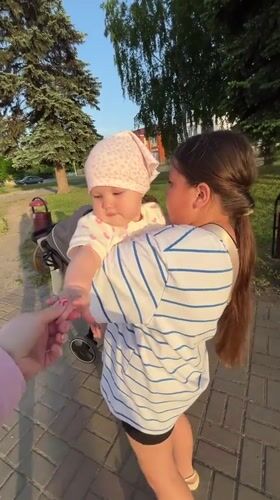 Family outing with baby documented in Novopokrovskaya park