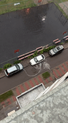 Rainy day aerial over a wet residential courtyard
