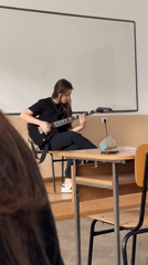 Guitar practice and cash counting captured in Zlatograd classroom