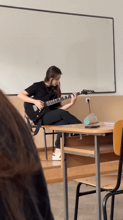 Guitar practice and cash counting captured in Zlatograd classroom