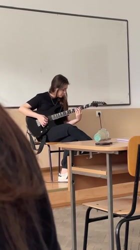 Guitar practice and cash counting captured in Zlatograd classroom