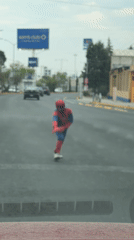 Child in Spider-Man costume performs street handstand in Mexico