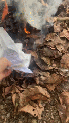 Person burns papers and objects in small fire in Thailand