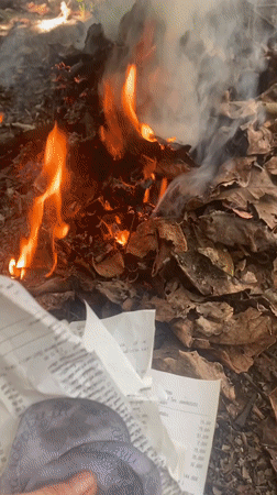Person burns papers and objects in small fire in Thailand
