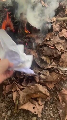 Person burns papers and objects in small fire in Thailand