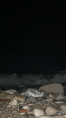 Nighttime waves captured washing over rocky beach near Bar