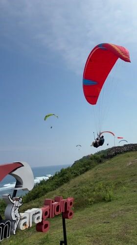 Paragliders take flight over Indonesian coast near Bali