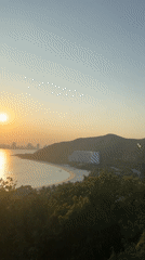Coastal resort with Ferris wheel documented during sunset hours