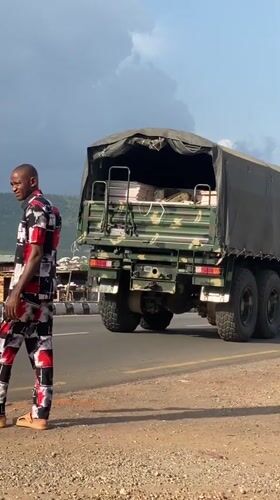 Civilian walks near military truck in Adankolo, Nigeria