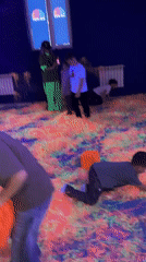Children play on neon foam floor at amusement center