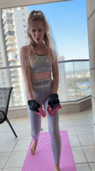 Woman exercises on balcony in Petah Tikva, documents workout