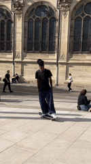 Skateboarder spotted near stone sculpture in Paris plaza