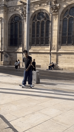 Skateboarder spotted near stone sculpture in Paris plaza