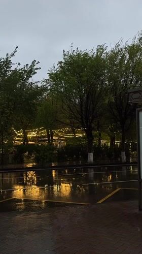 Rainy afternoon captures wet streets and taxi in Gyumri