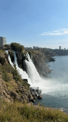 Waterfall streams cascade over cliff into sea near Antalya