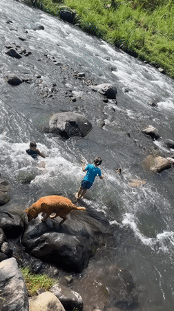 River day in Klungkung — kids, adults, and a golden retriever