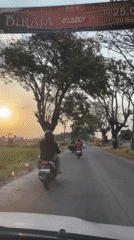 Two angles on busy road traffic with scooters and pedestrians