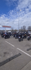 Large motorcycle gathering observed in outdoor parking area
