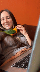 Woman spends morning with pet Sun Conure parrot in Khimki