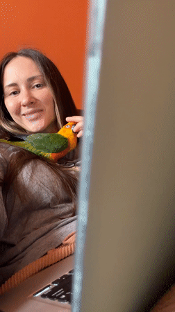 Woman spends morning with pet Sun Conure parrot in Khimki