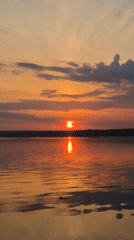 Sunset captured over calm waters in Chaikovsky, Russia