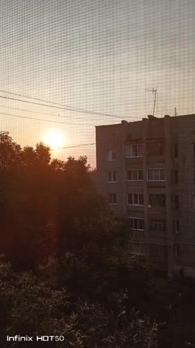 Late-night sunset and windowsill plants in Izhevsk