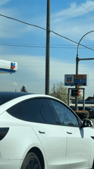 White Tesla with N sticker waits in Burnaby traffic