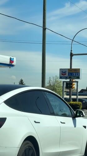 White Tesla with N sticker waits in Burnaby traffic