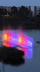 Colorful fountain light show on a Tallinn lake at dusk