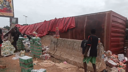 Commercial truck overturns in Jos, Nigeria, spilling cargo